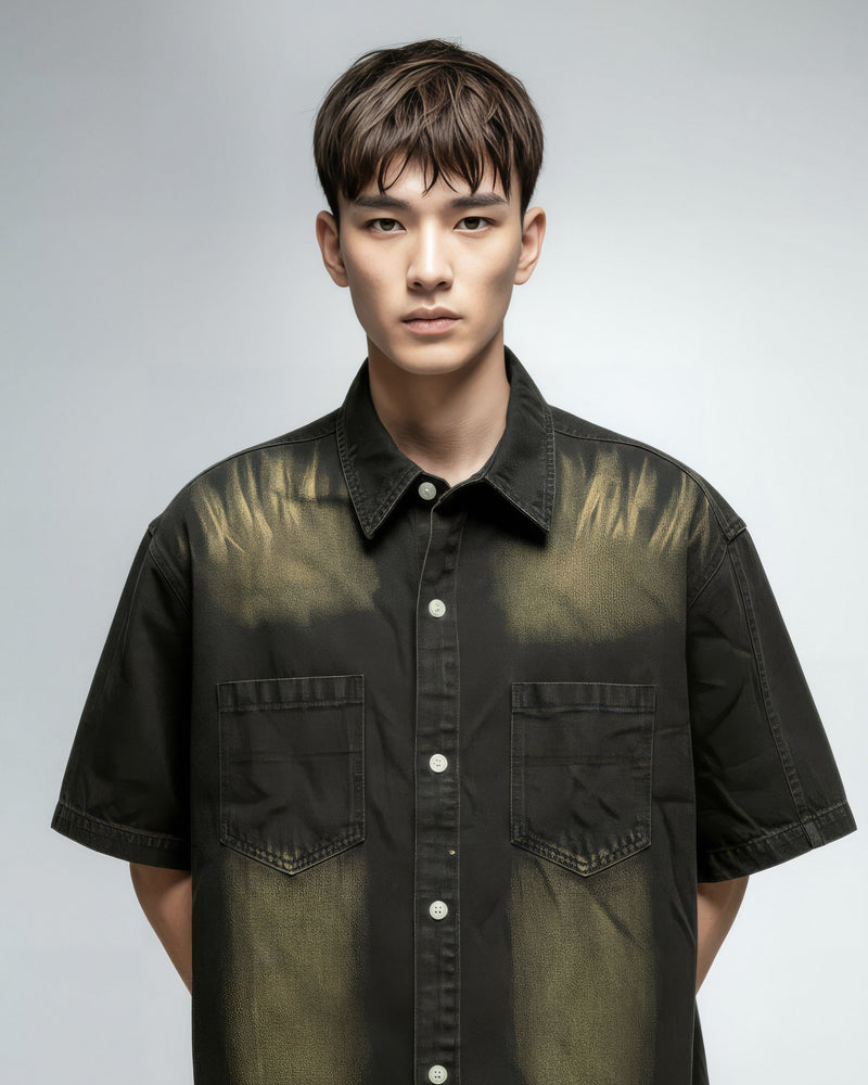 Man wearing a black and green gradient shirt against a gray background